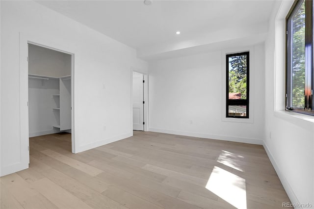 1491 S York St, Denver, CO 80210 - unfurnished bedroom featuring light wood-style flooring, a walk in closet, and recessed lighting