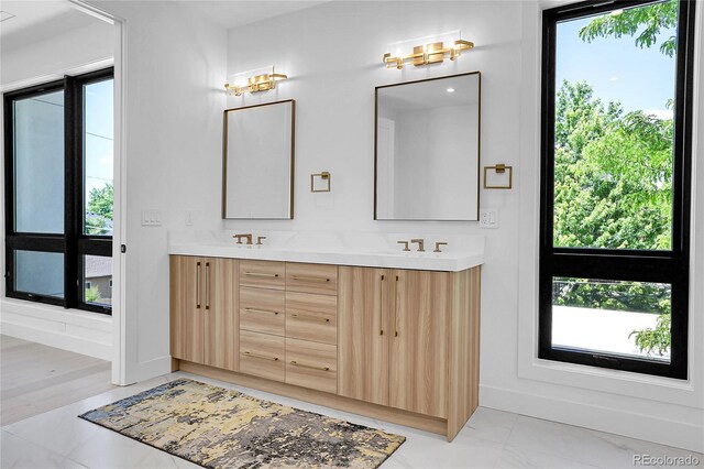 1491 S York St, Denver, CO 80210 - full bath with double vanity, plenty of natural light, and marble finish floors