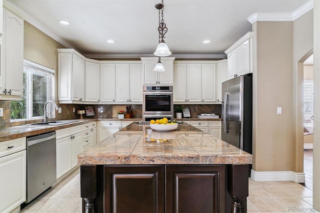 kitchen featuring decorative light fixtures, backsplash, a center island, and stainless steel appliances