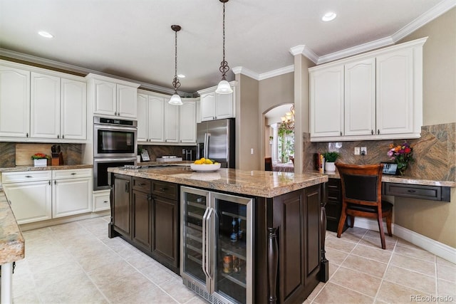 kitchen with decorative backsplash, light stone countertops, beverage cooler, and appliances with stainless steel finishes