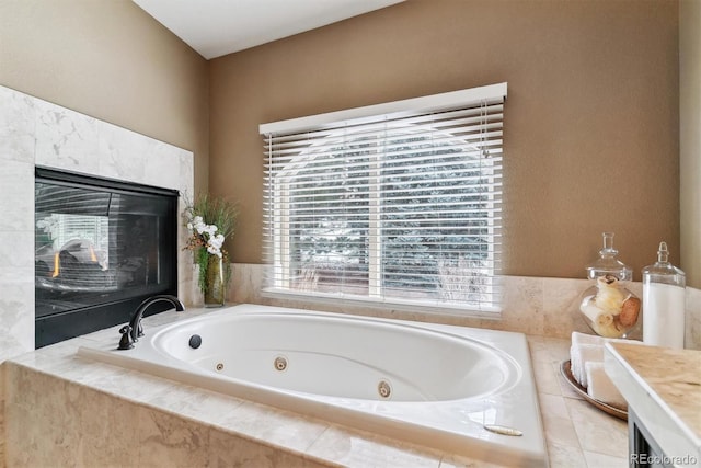 bathroom with tiled tub and a high end fireplace