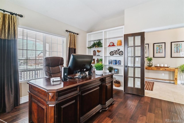 office featuring dark hardwood / wood-style floors, lofted ceiling, and french doors