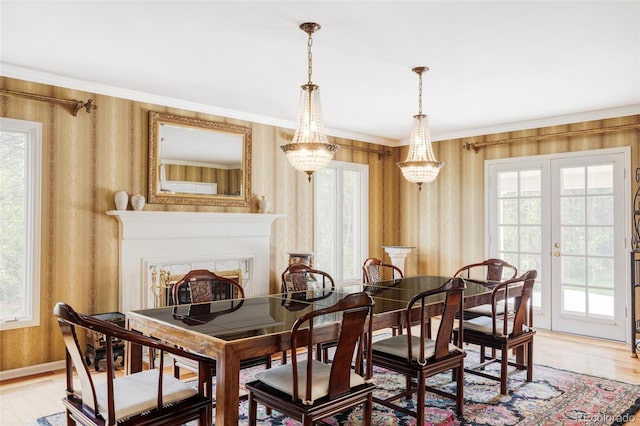 2209 Green Oaks Ln, Greenwood Village, CO 80121 - dining area with wallpapered walls, light wood finished floors, plenty of natural light, crown molding, and baseboards