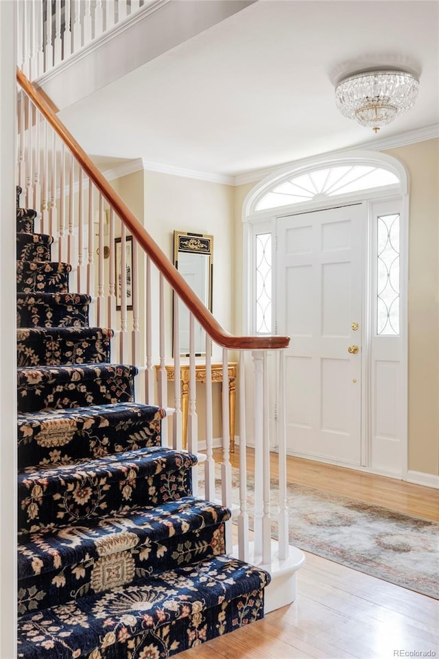 2209 Green Oaks Ln, Greenwood Village, CO 80121 - entrance foyer with wood finished floors, crown molding, and stairway