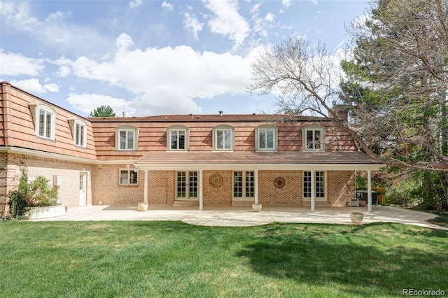 2209 Green Oaks Ln, Greenwood Village, CO 80121 - rear view of property featuring mansard roof, a patio, a lawn, and brick siding
