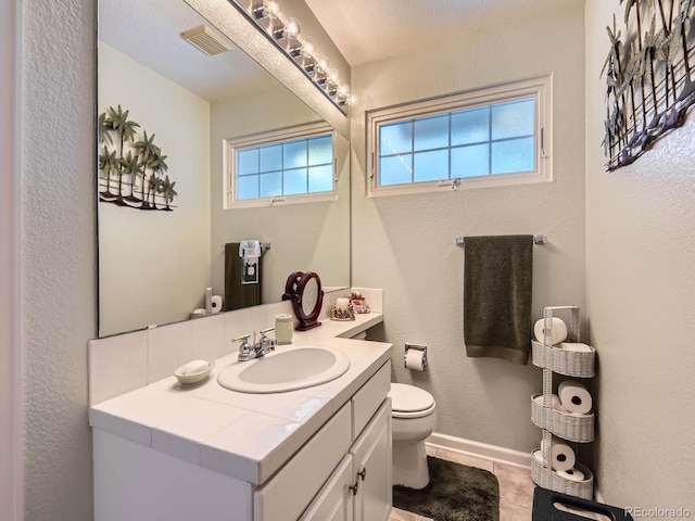 2676 S Troy Ct, Aurora, CO 80014 - bathroom with baseboards, visible vents, toilet, tile patterned floors, and vanity