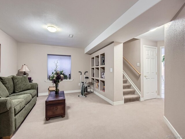 2676 S Troy Ct, Aurora, CO 80014 - carpeted living area featuring stairs, a textured ceiling, baseboards, and built in features