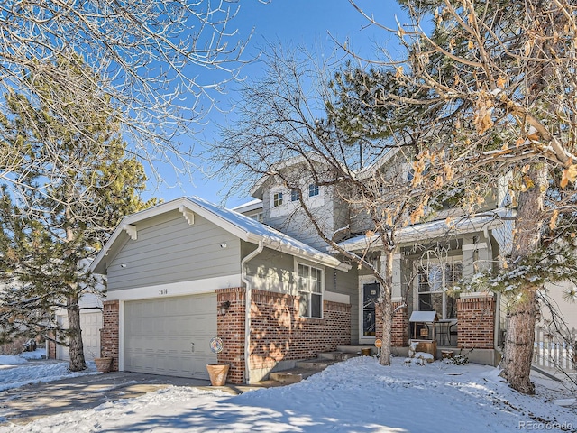2676 S Troy Ct, Aurora, CO 80014 - view of front facade featuring a garage, brick siding, and a porch