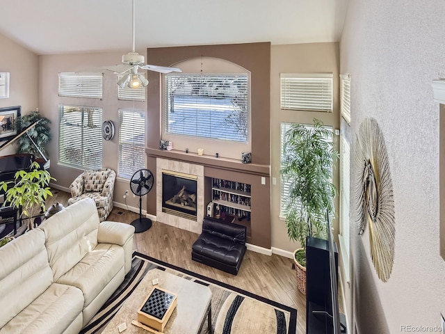 2676 S Troy Ct, Aurora, CO 80014 - living room with a ceiling fan, a tile fireplace, baseboards, and wood finished floors