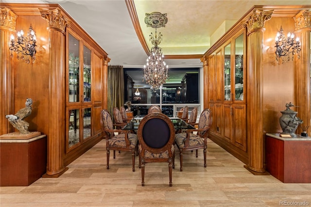 dining area with light hardwood / wood-style flooring and a chandelier