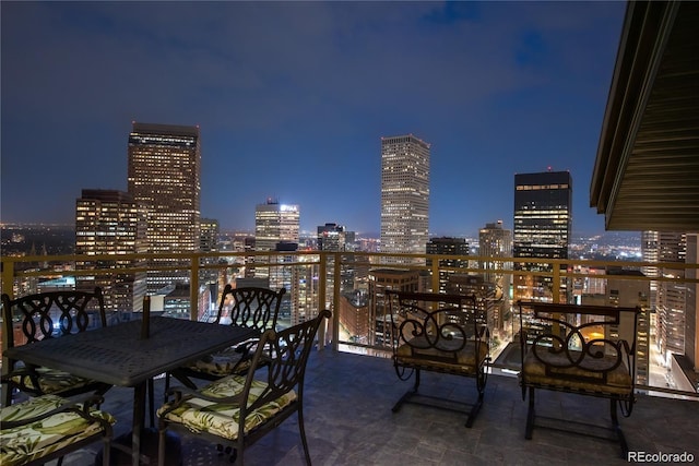 patio at twilight featuring a balcony