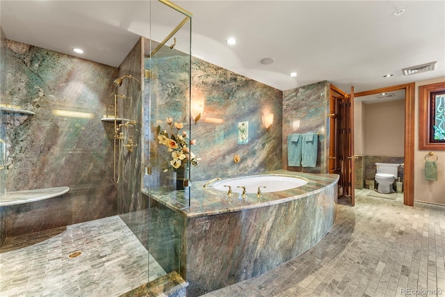 bathroom featuring tile patterned floors, independent shower and bath, tile walls, and toilet