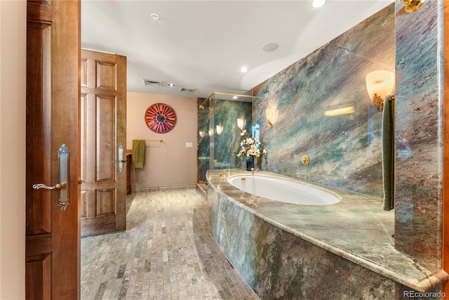 bathroom featuring a relaxing tiled tub