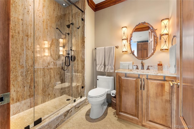 bathroom featuring vanity, crown molding, tile patterned floors, toilet, and a shower with door