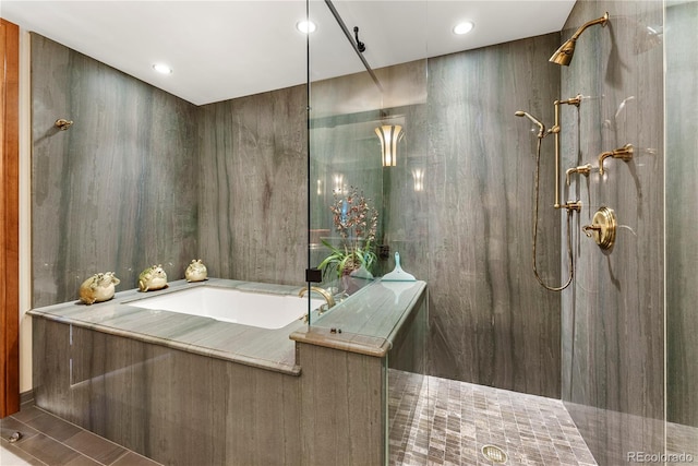 bathroom with tile patterned floors and a tile shower