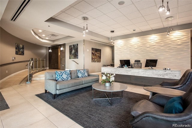 tiled living room featuring a raised ceiling