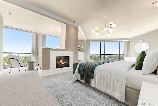 carpeted bedroom with multiple windows, a notable chandelier, crown molding, and a premium fireplace