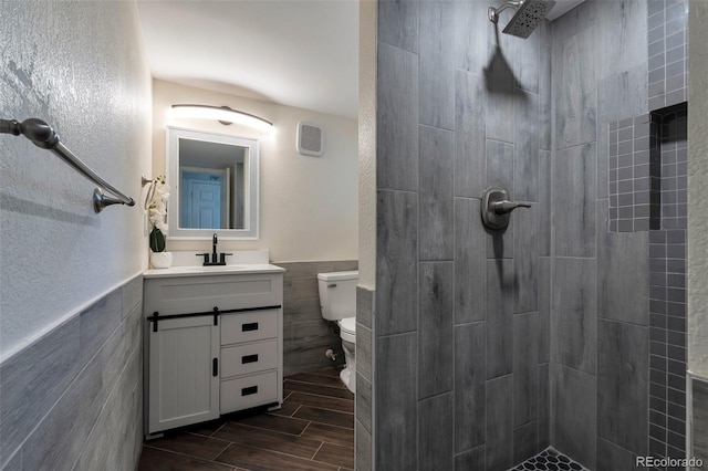 3807 S Atchison Way, Aurora, CO 80014 - full bathroom with tile walls, tiled shower, vanity, wood tiled floors, and wainscoting