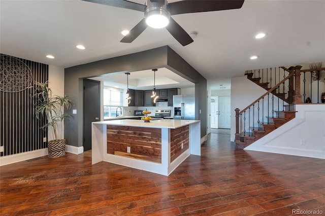 3807 S Atchison Way, Aurora, CO 80014 - kitchen featuring appliances with stainless steel finishes, dark wood-style floors, light countertops, recessed lighting, and pendant lighting