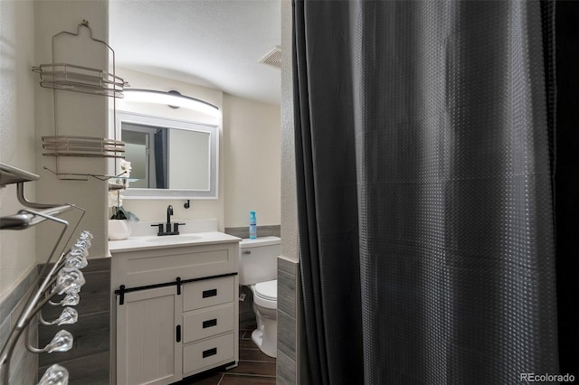3807 S Atchison Way, Aurora, CO 80014 - bathroom featuring vanity, wood finished floors, and curtained shower