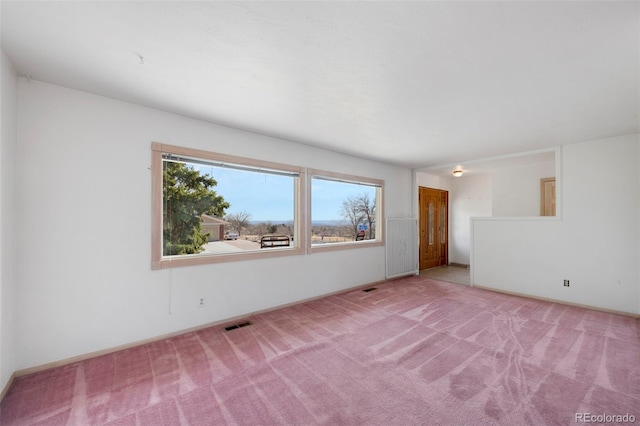 unfurnished room featuring visible vents and carpet floors