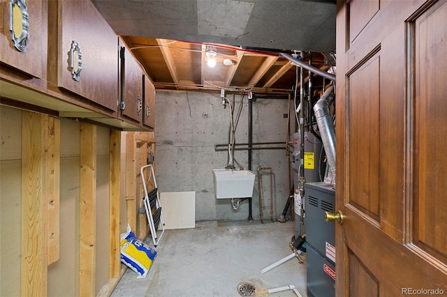 unfinished basement with gas water heater and a sink