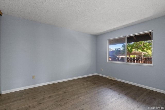 3720 S Fairplay Way, Aurora, CO 80014 - unfurnished room with dark wood-style flooring, a textured ceiling, and baseboards