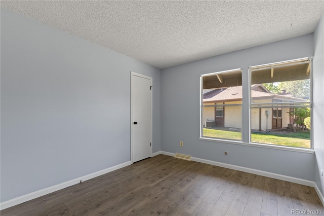 3720 S Fairplay Way, Aurora, CO 80014 - unfurnished room with wood finished floors, a textured ceiling, and baseboards