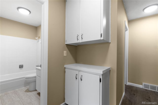 3720 S Fairplay Way, Aurora, CO 80014 - full bath with toilet, shower / tub combination, vanity, baseboards, and wood finished floors