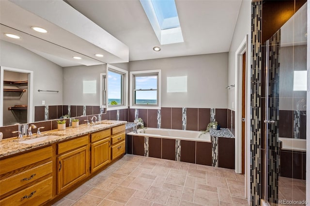 bathroom with vanity, independent shower and bath, and lofted ceiling