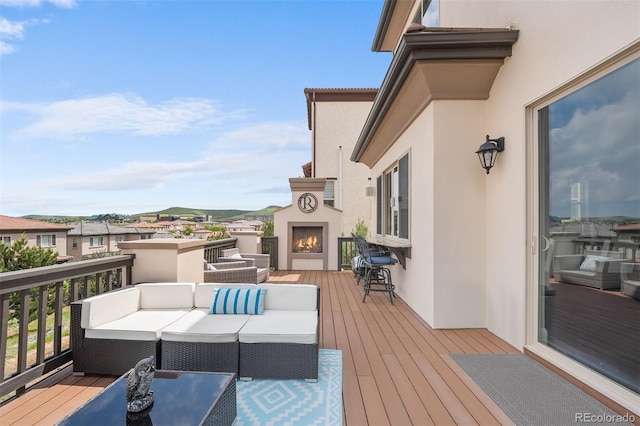 10468 Ladera Dr, Lone Tree, CO 80124 - wooden deck with an outdoor living space with a fireplace