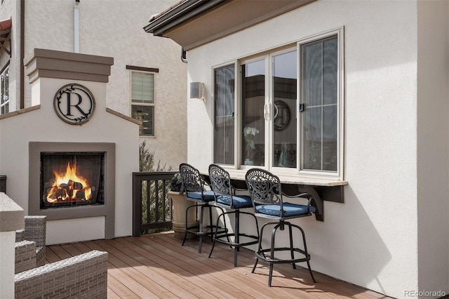 10468 Ladera Dr, Lone Tree, CO 80124 - wooden deck featuring a warm lit fireplace