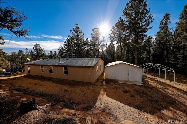 view of home's exterior with a storage shed and a carport