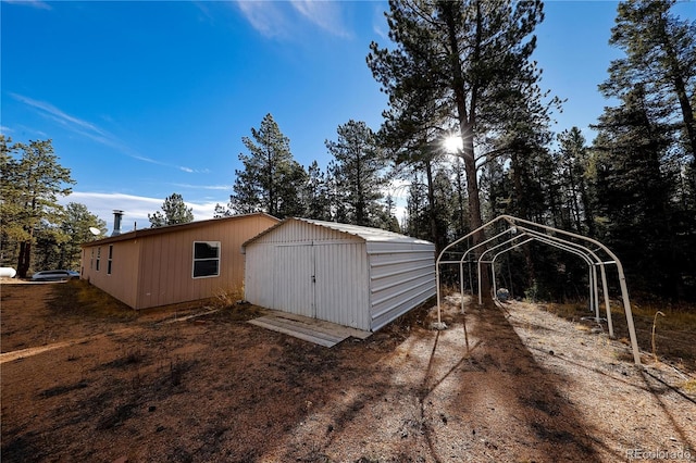 view of outbuilding with a carport