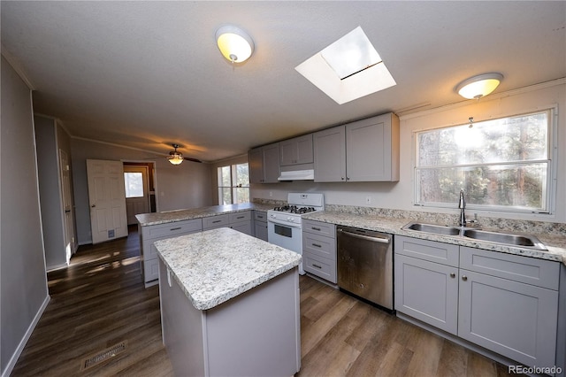 kitchen with dishwasher, a kitchen island, gray cabinetry, gas range gas stove, and dark hardwood / wood-style flooring