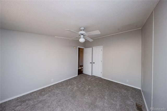 carpeted spare room with a textured ceiling and ceiling fan