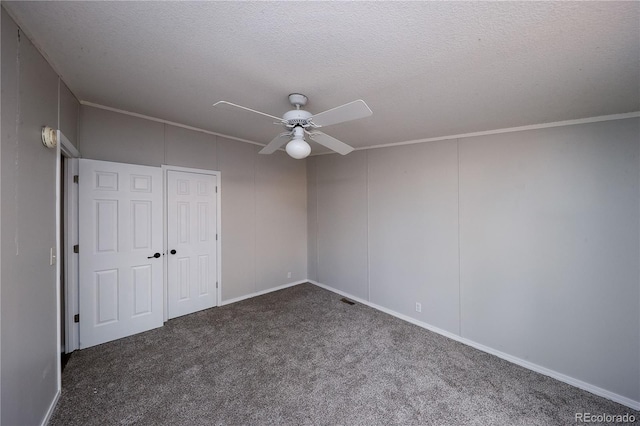 carpeted empty room with crown molding, a textured ceiling, and ceiling fan