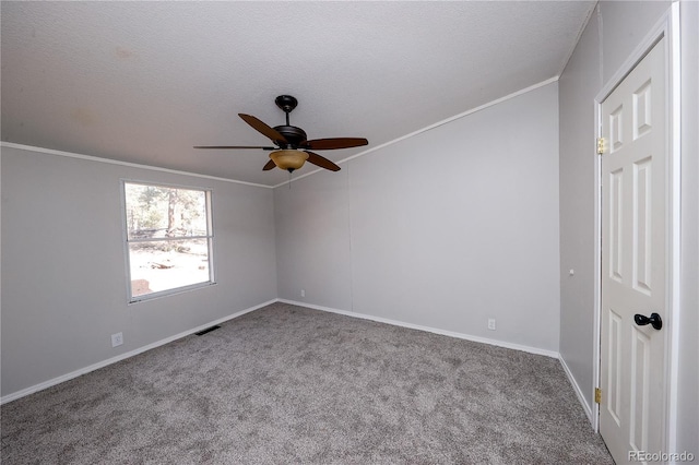 carpeted spare room with crown molding, a textured ceiling, and ceiling fan