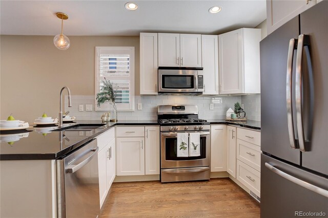 kitchen with white cabinets and appliances with stainless steel finishes