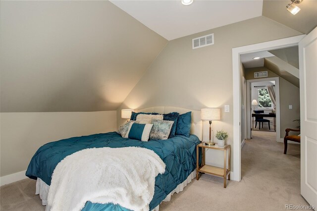 bedroom featuring light colored carpet and vaulted ceiling