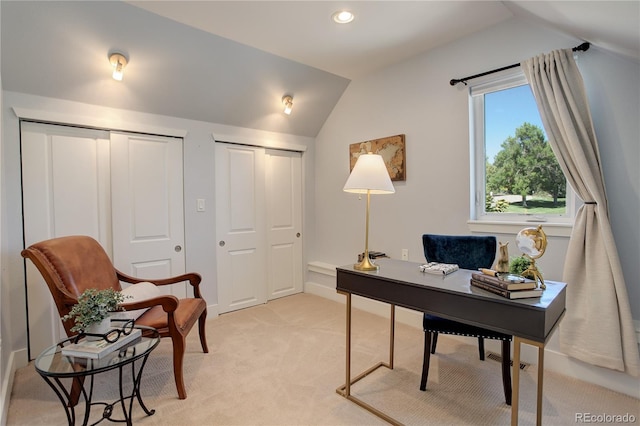 office area featuring light colored carpet and vaulted ceiling