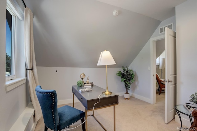 carpeted office space with vaulted ceiling