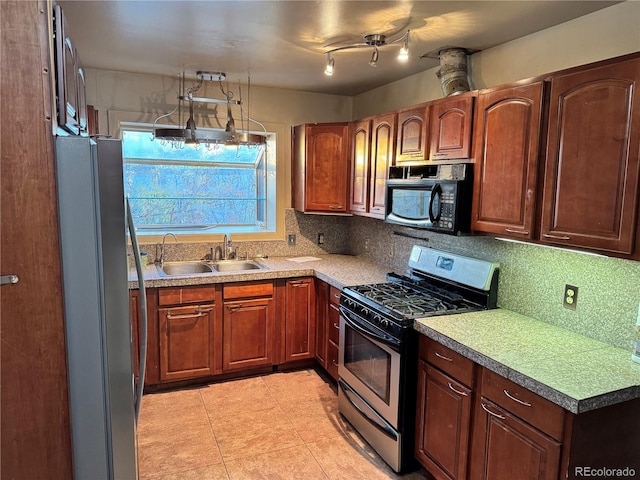 kitchen featuring decorative backsplash, sink, light tile patterned flooring, and appliances with stainless steel finishes