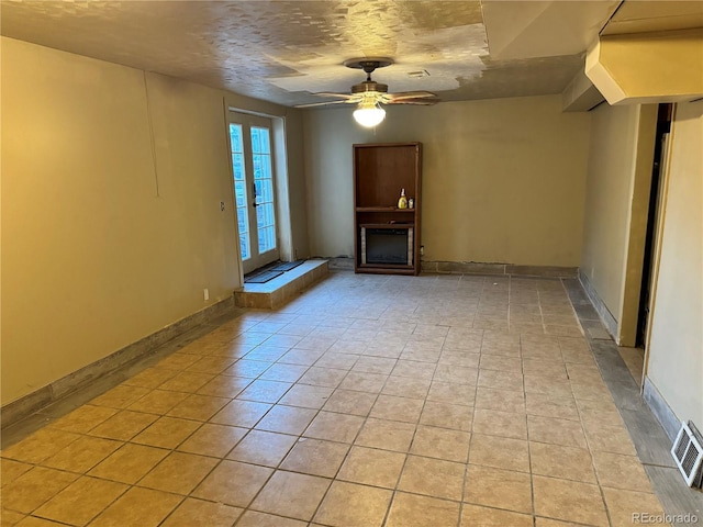 unfurnished living room featuring a textured ceiling and ceiling fan