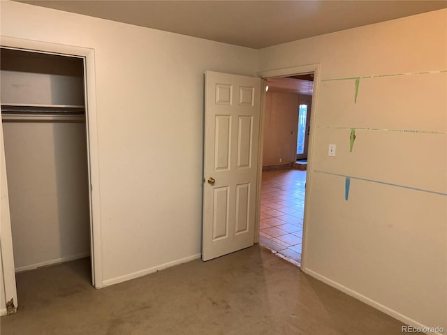 unfurnished bedroom featuring a closet and carpet