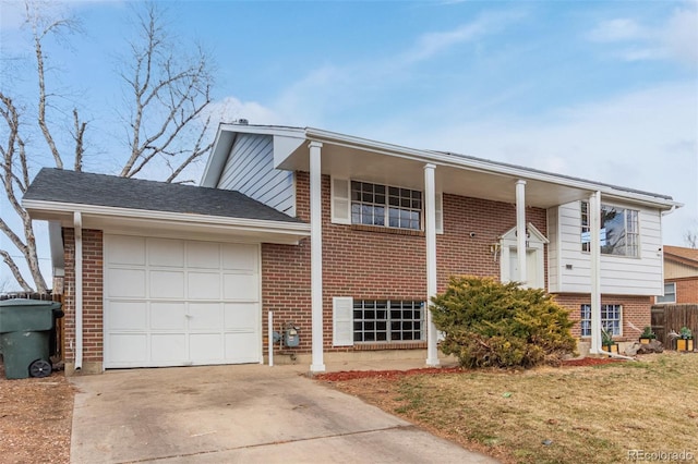 view of front of home with a garage, concrete driveway, and brick siding