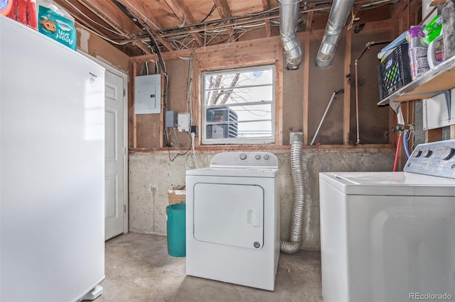 clothes washing area with electric panel and washer and dryer