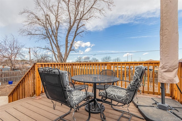 wooden deck featuring outdoor dining space and fence