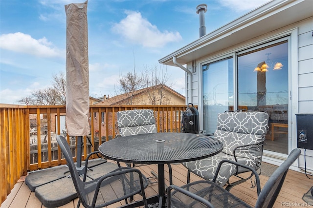 wooden deck featuring outdoor dining area