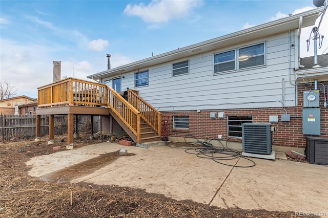 rear view of property with central AC, brick siding, fence, stairs, and a patio area